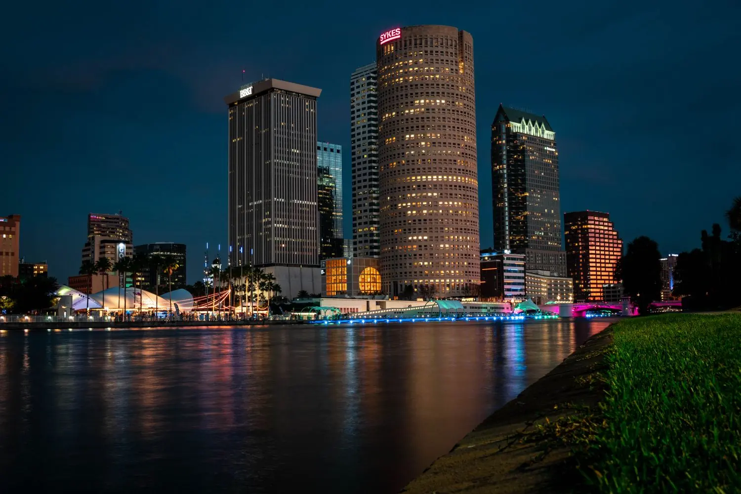 Downtown Tampa at night, with Rivergate Tower and 100 North Tampa reflected in the Hillsborough River